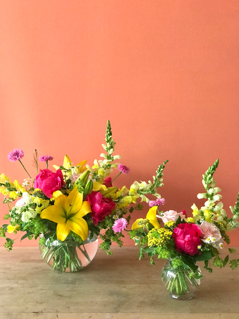 pink peonies, yellow lilies, calla lilies, in large and medium size arrangements